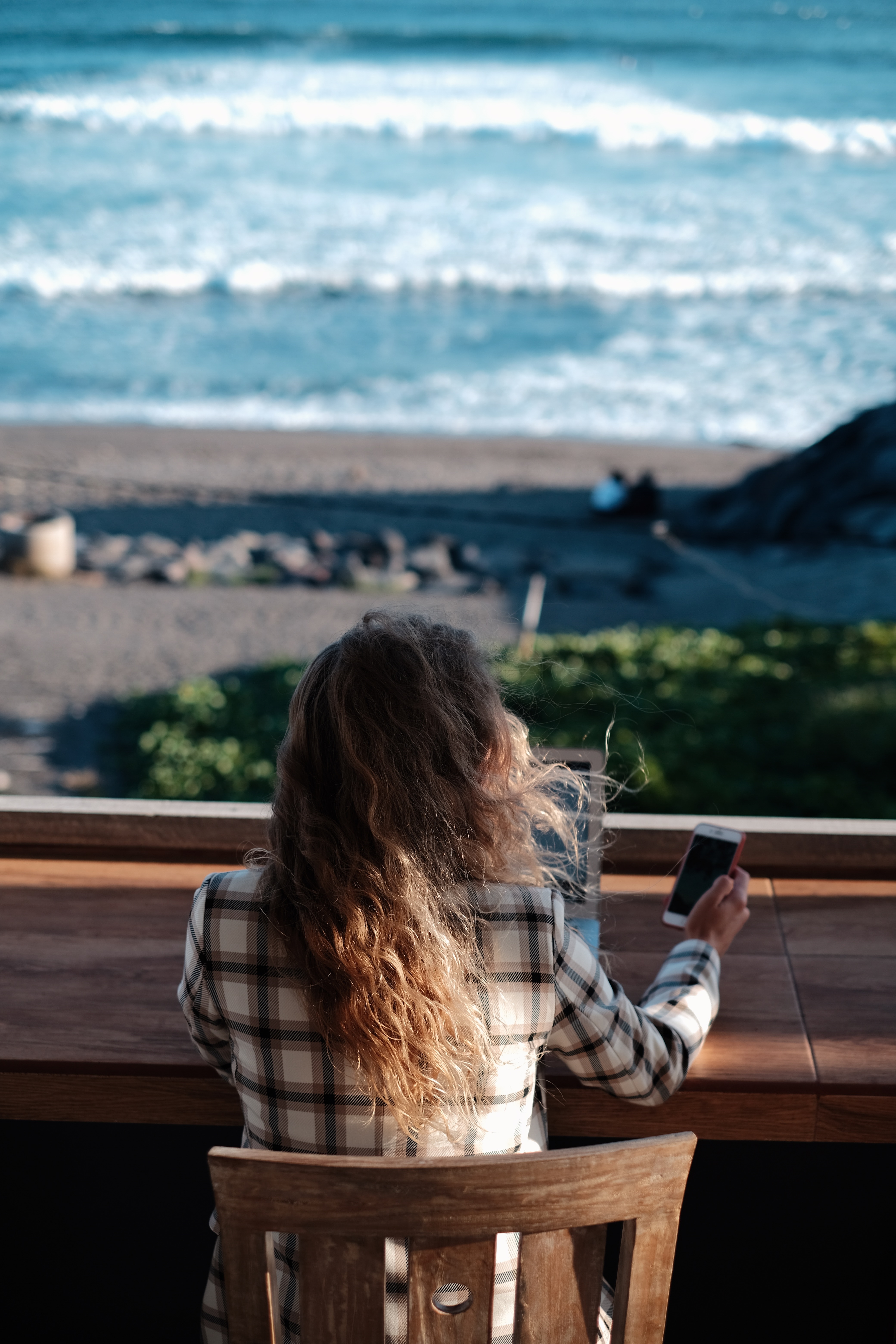 Woman working with a view of the beach